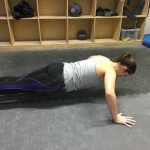 Girl doing push ups at the gym
