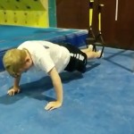 Young student working his core on the TRX bands