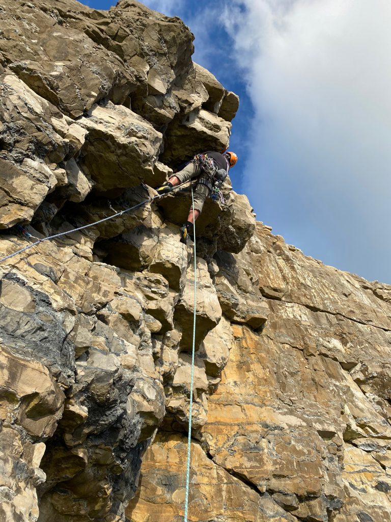 Climber Leading an outdoor climb - Jurassic Climbing, Dorset